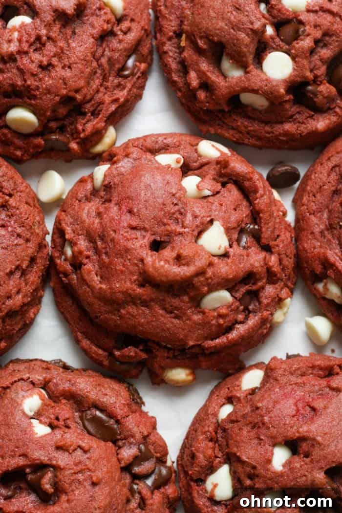 Delicious red velvet cookies stacked on a cooling rack, showcasing their vibrant red color and soft texture.