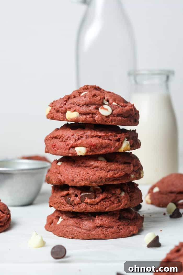 A stack of perfectly baked red velvet cookies, showing their rich red color and soft centers.