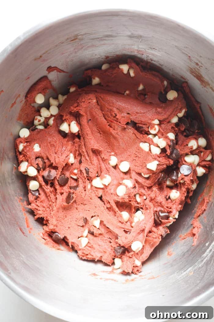 Red cookie dough studded with white and regular chocolate chips.
