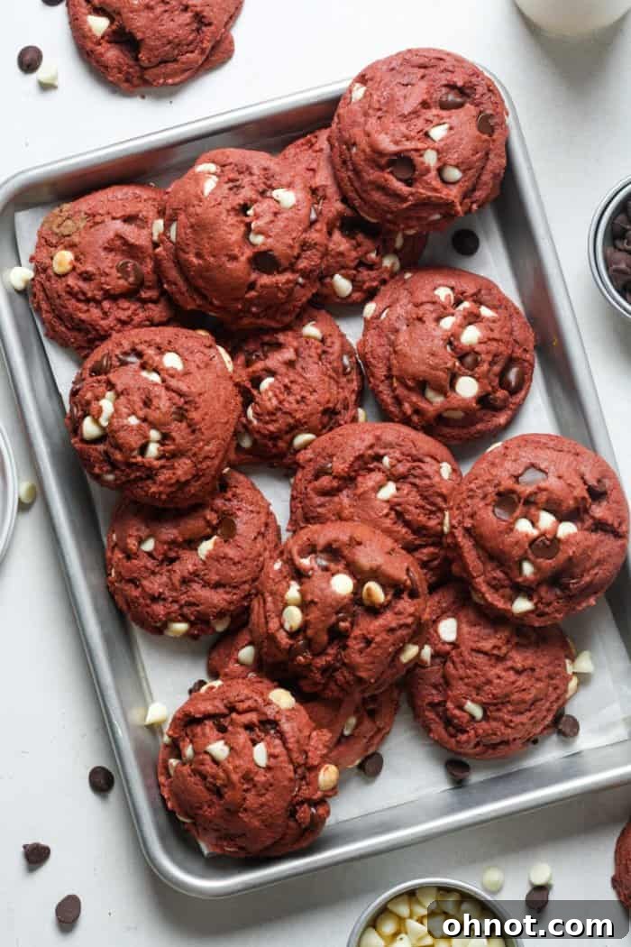 Freshly baked red velvet cookies with a vibrant red color straight from the oven.