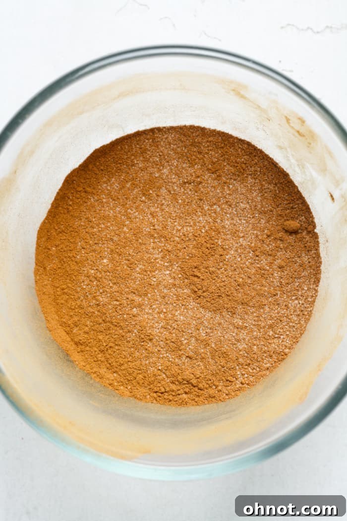 Cinnamon sugar coating mixture in a small white bowl, ready for use.