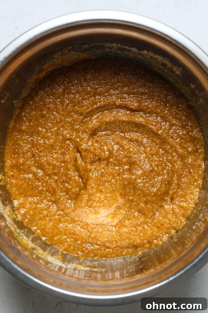 Creamy pumpkin batter in a mixing bowl, after dry ingredients have been stirred in, ready for the chocolate chips.