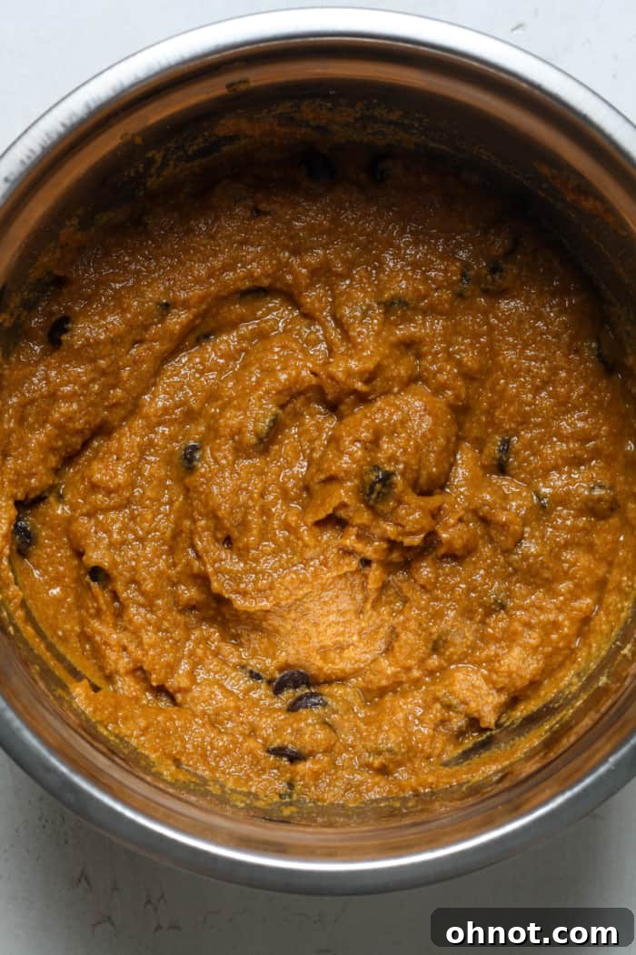 Pumpkin bread batter studded with chocolate chips, showcasing the final mixture before baking.