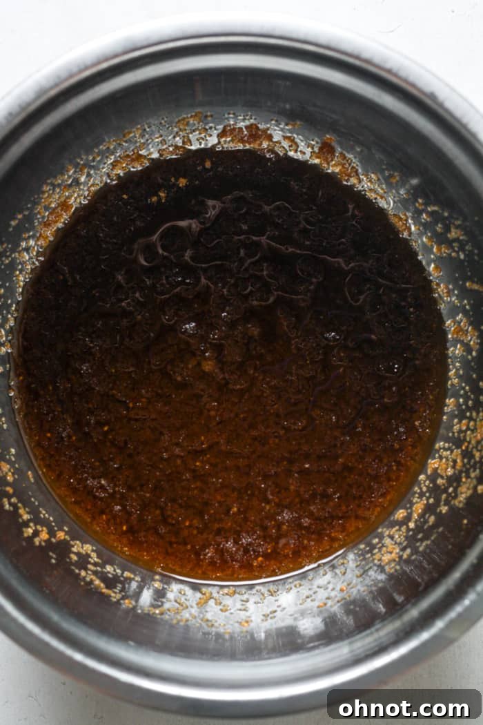 Brown sugar and butter mixed together in a bowl for blondie batter.