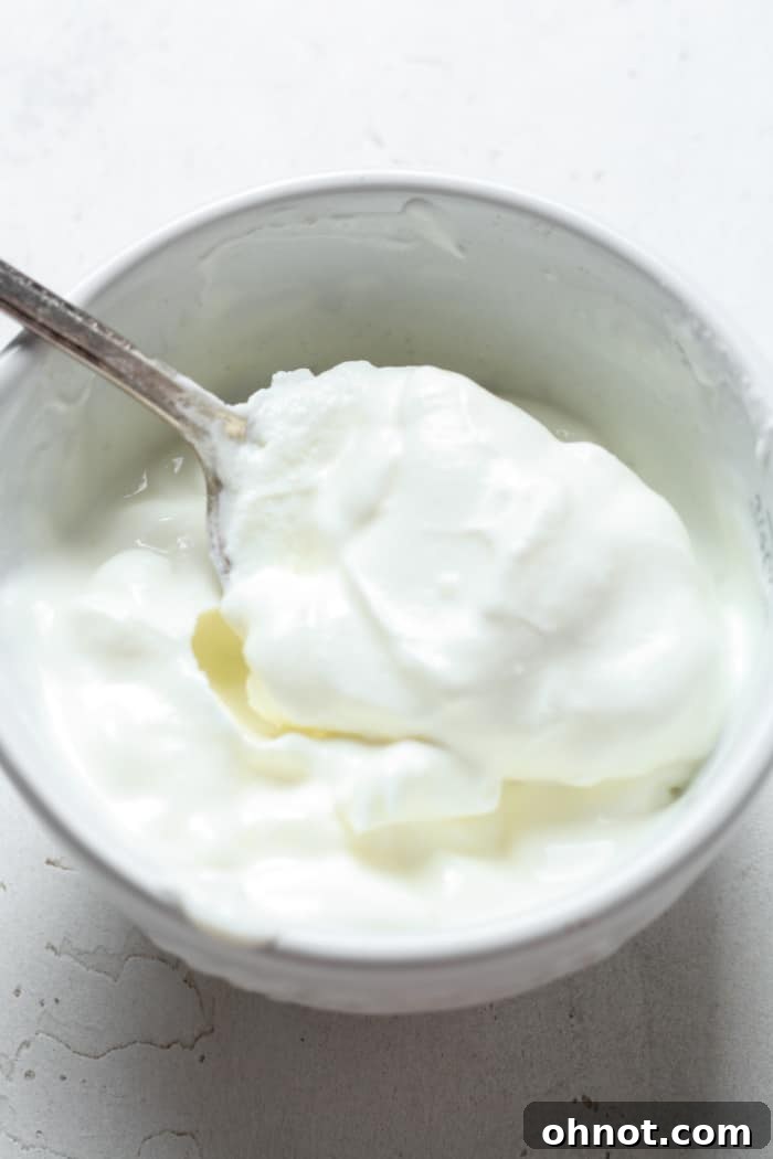 Freshly made dairy-free sour cream in a white bowl, ready to serve.