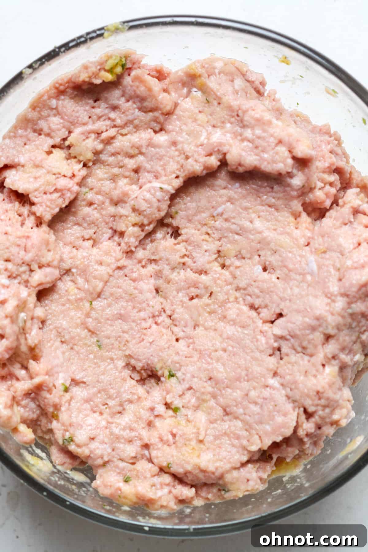 The ground turkey mixture thoroughly combined in a mixing bowl.
