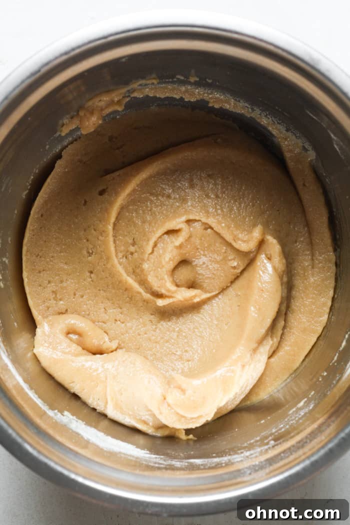 Swirl of blondie dough with dry ingredients added.