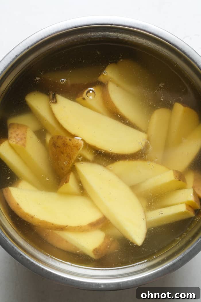Bowl with water and potatoes.