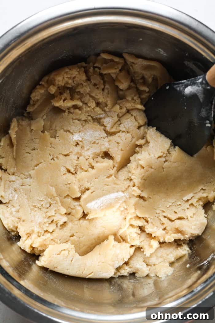 Light colored vegan cookie dough forming in the bowl.