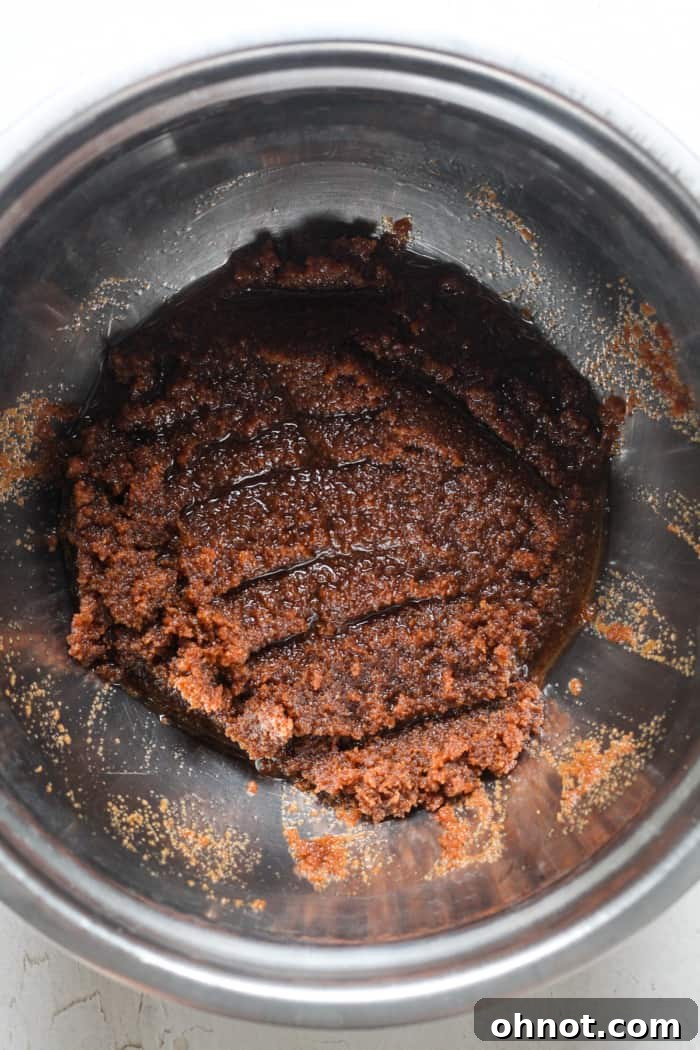 Melted coconut oil and coconut sugar in a mixing bowl.