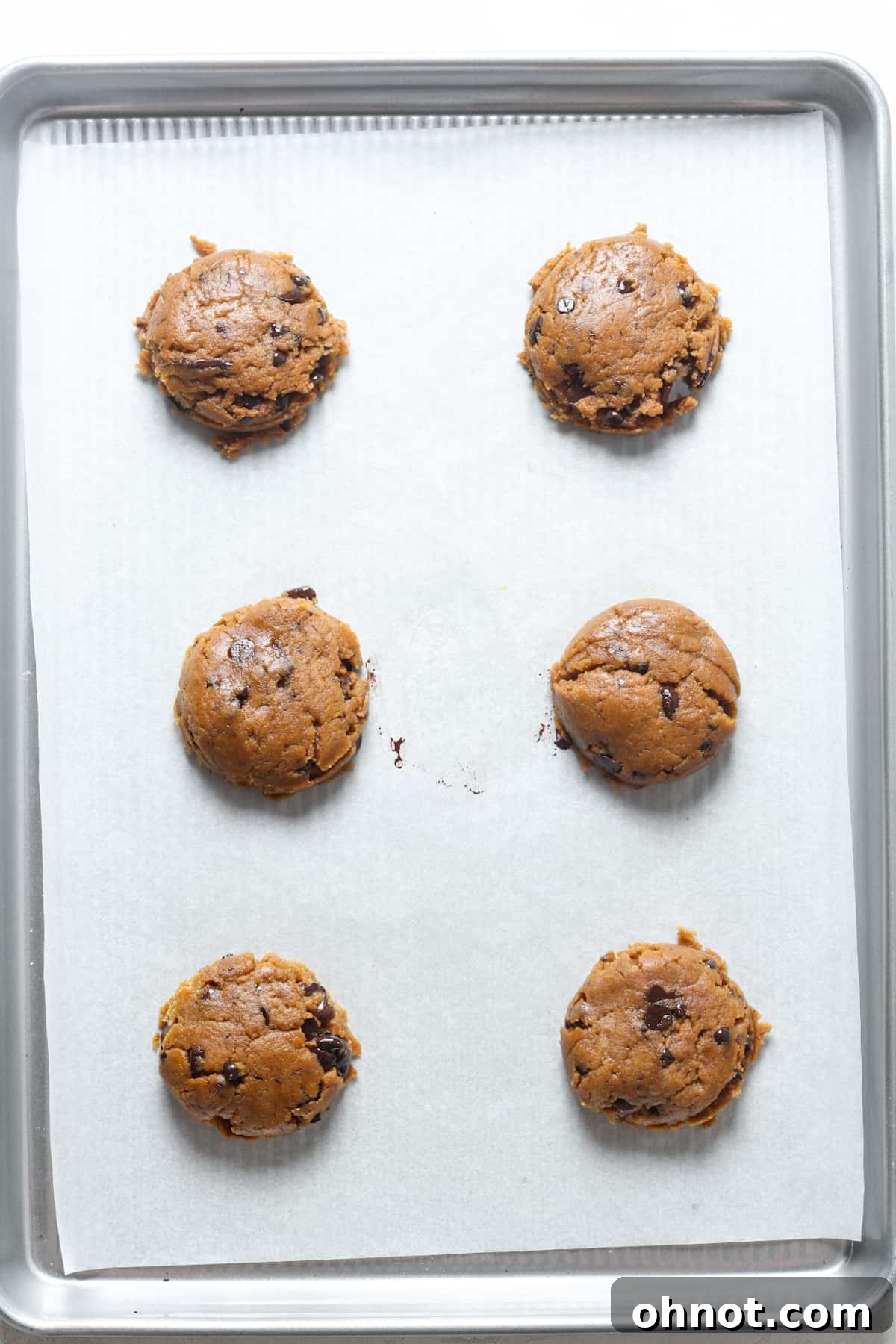 Flattened cookie dough balls ready for baking.