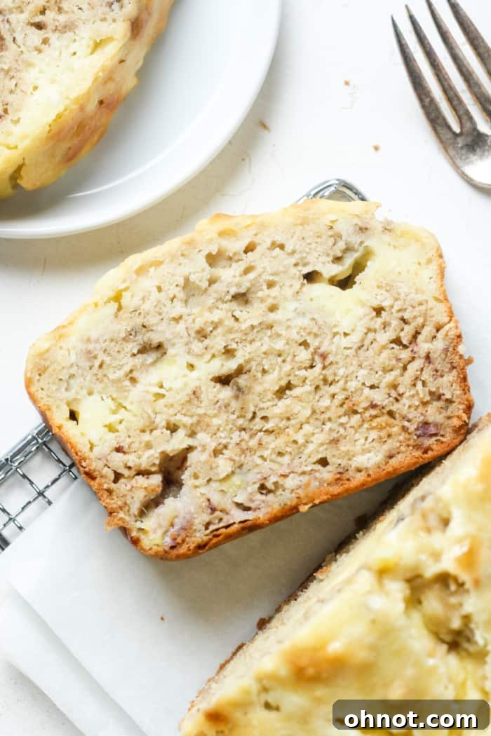 Cream cheese banana bread, perfectly baked with a visible cream cheese swirl.