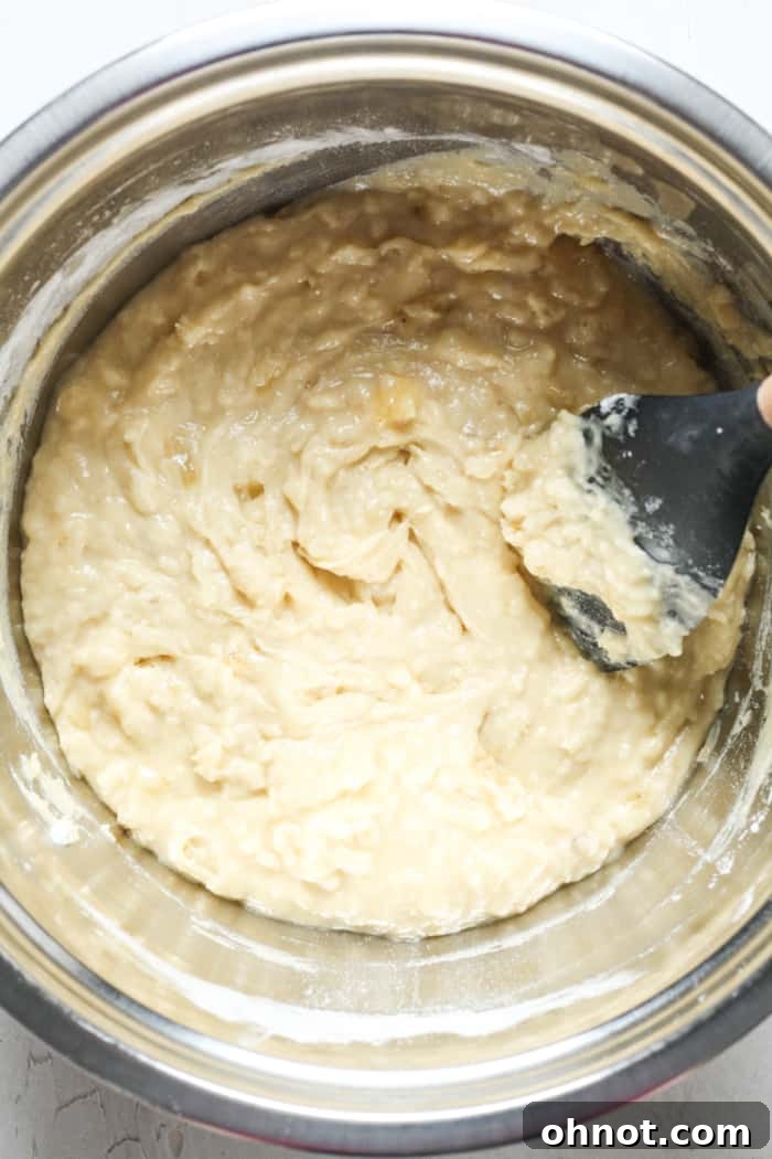 Smooth banana bread batter in a mixing bowl.
