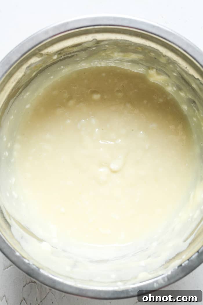 Creamy cream cheese filling in a stand mixer bowl.