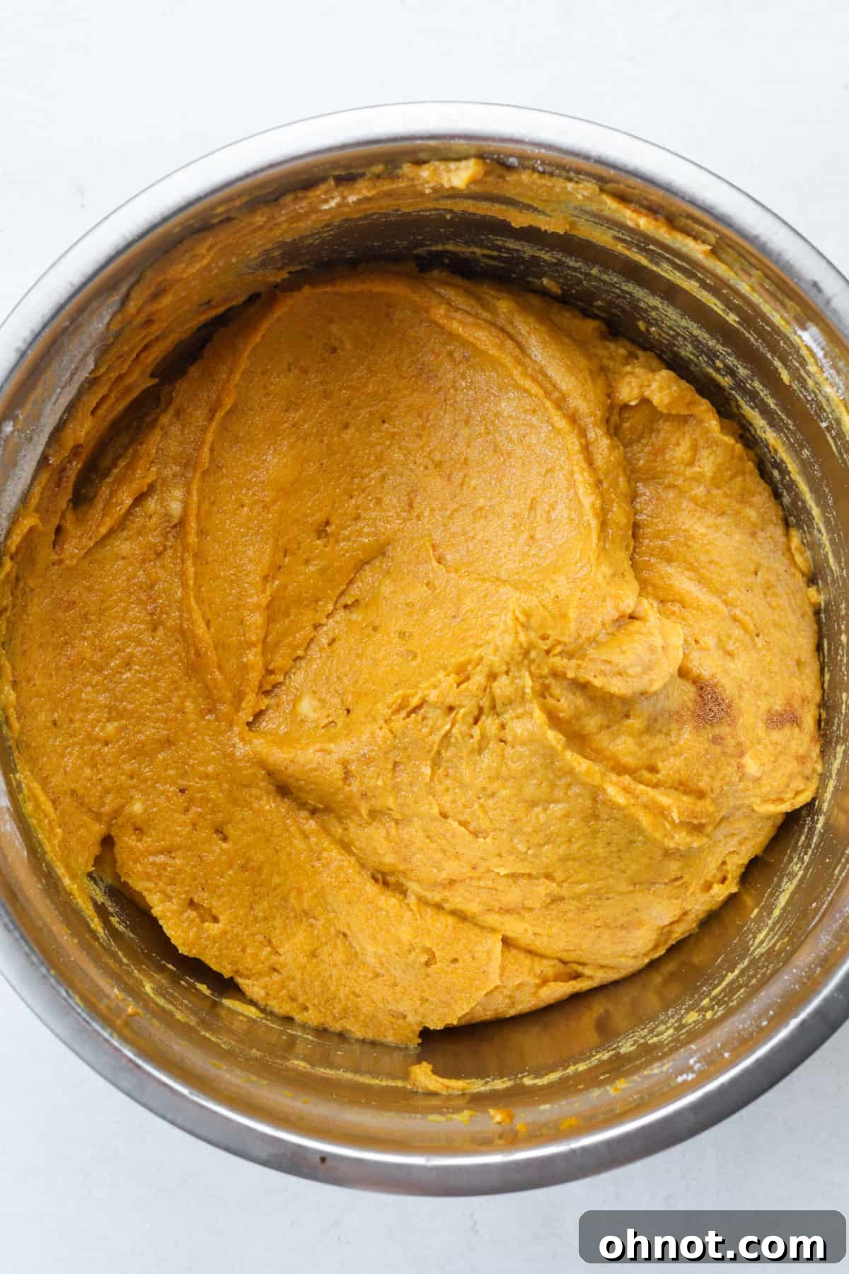 Thick, spiced orange muffin batter ready for baking.