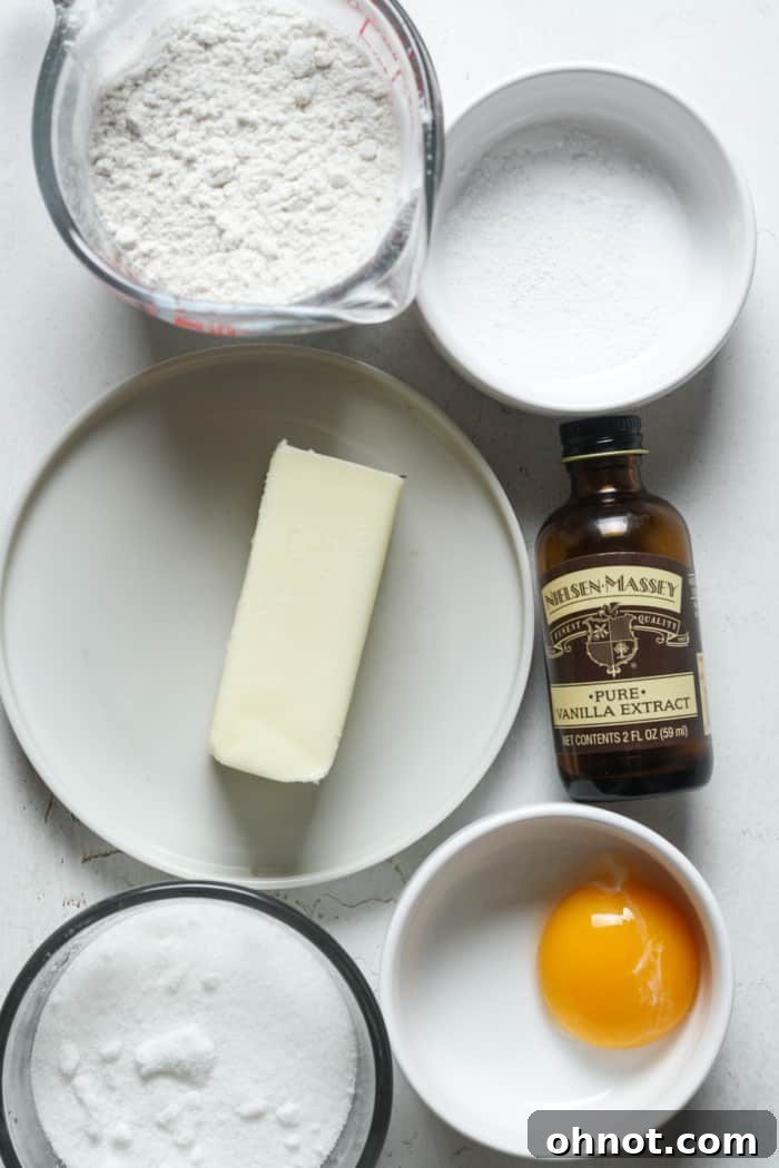 Close-up of the essential ingredients: cold butter, egg yolk, and vanilla extract, ready for mixing.