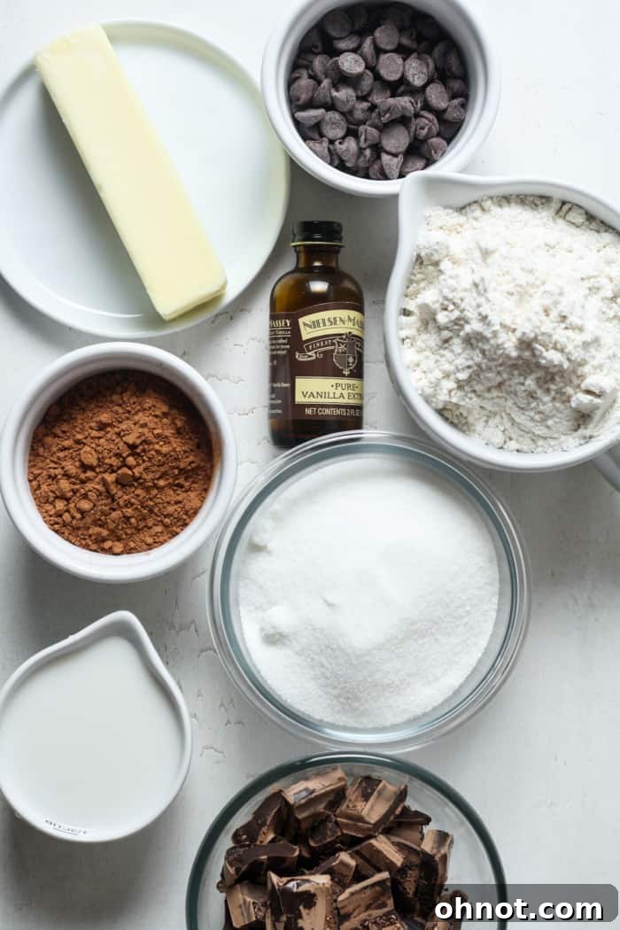 Assorted vegan brownie ingredients, including chopped chocolate, butter, and flour, arranged for baking.