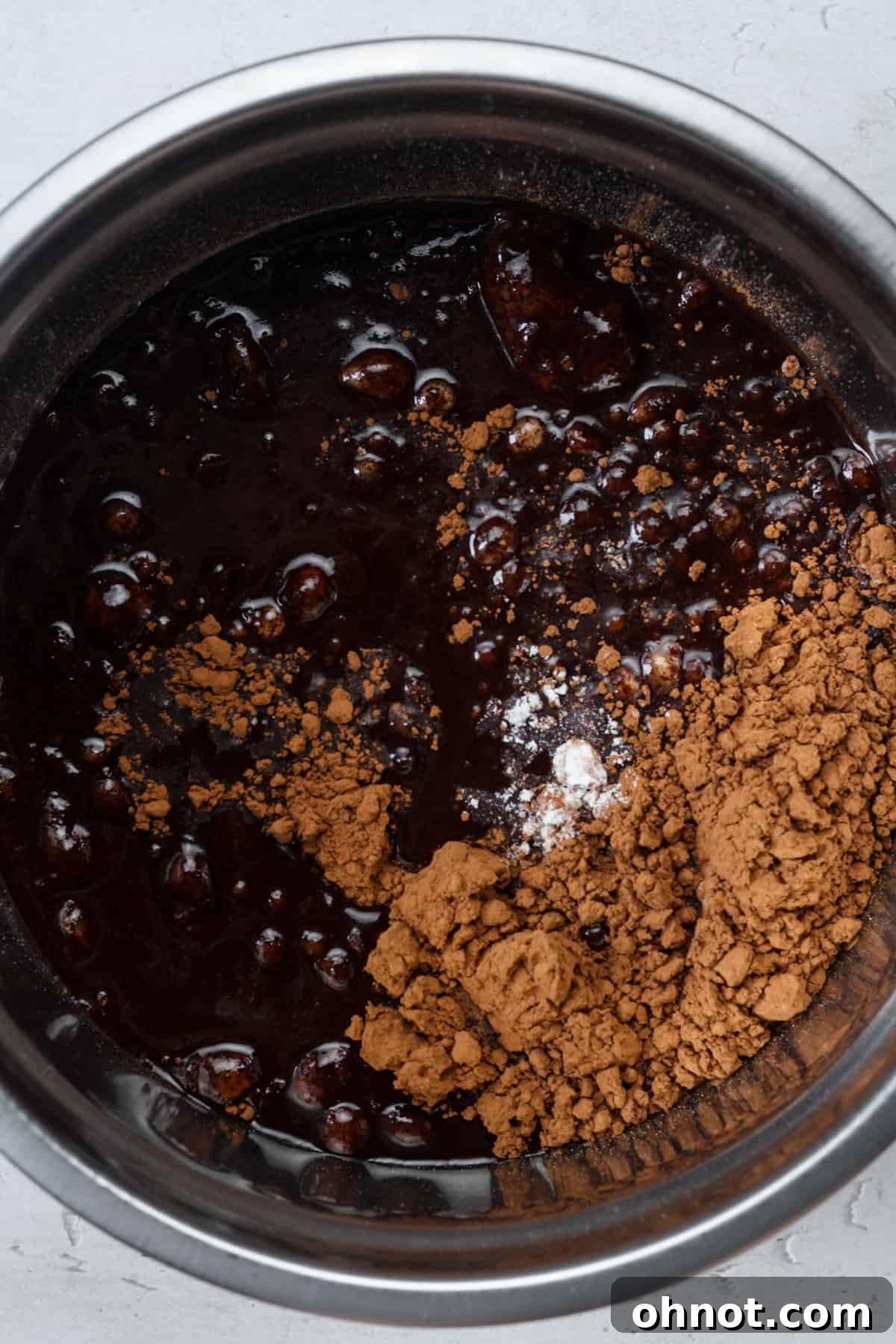 The vegan brownie batter in a mixing bowl, thick and luscious, before baking.