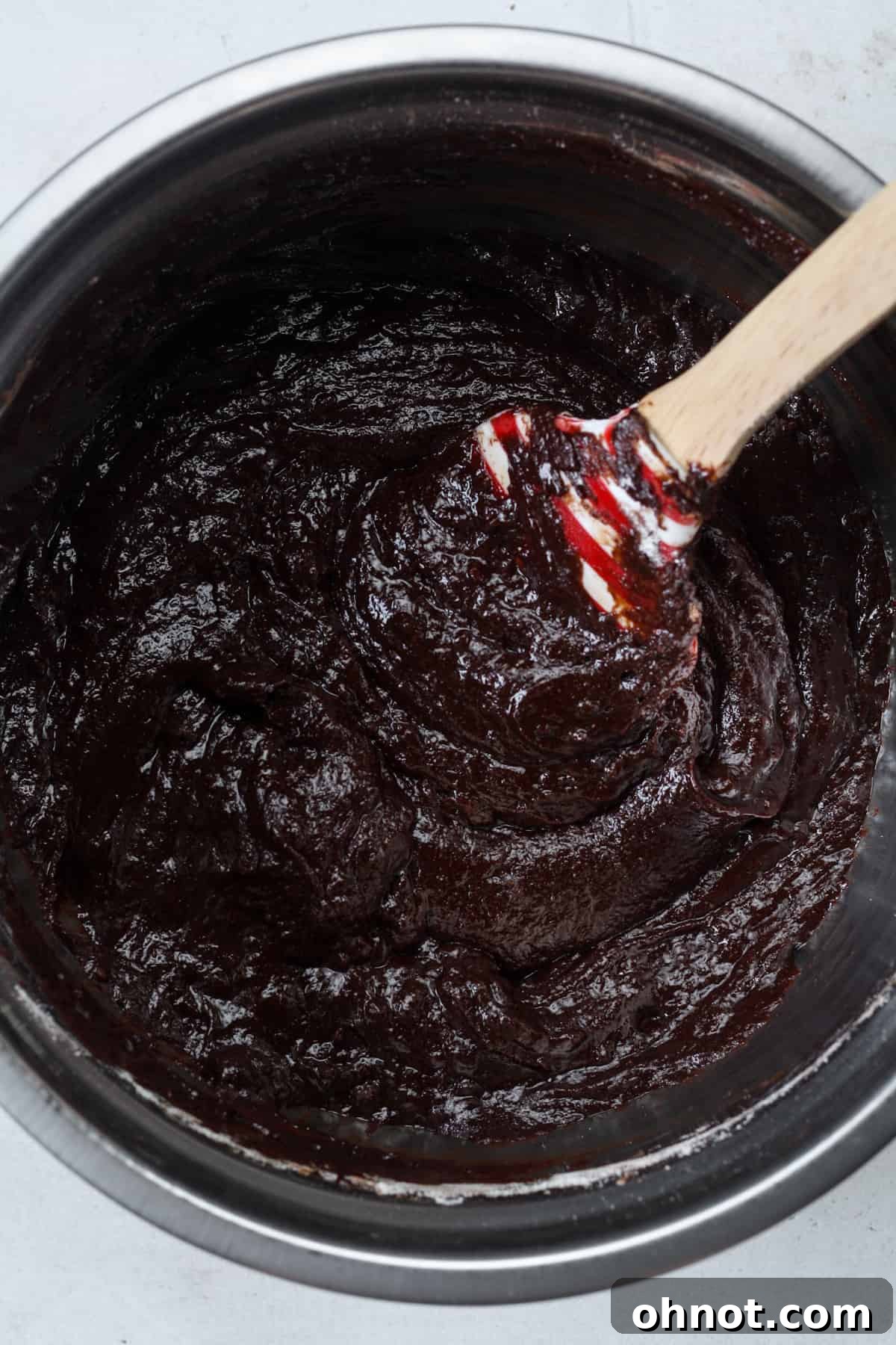 Thick, rich vegan brownie batter in a bowl, perfectly combined and ready for the next step.