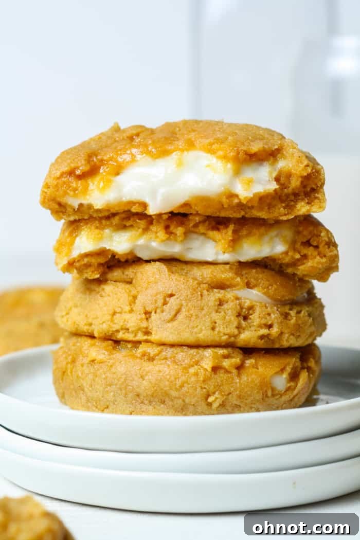 Soft-baked pumpkin cheesecake cookies with a gooey cream cheese filling, perfect for fall desserts.