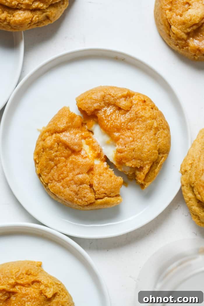 A stack of delicious pumpkin cheesecake cookies, showing their soft texture and creamy filling.