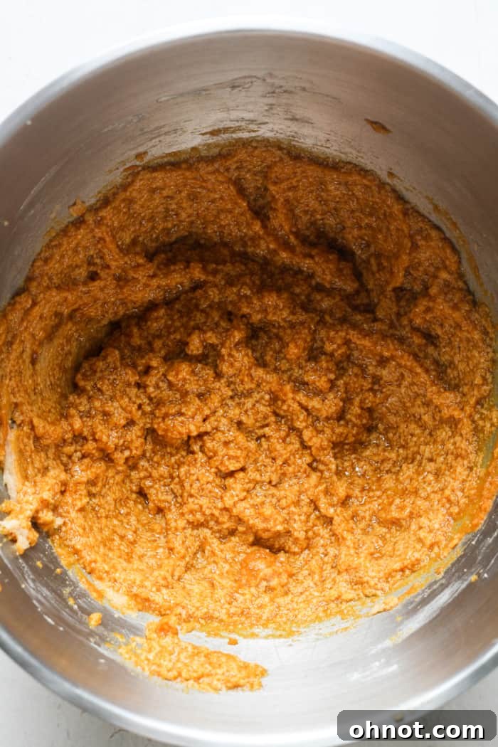 Gooey pumpkin dough mixed with egg and vanilla extract.