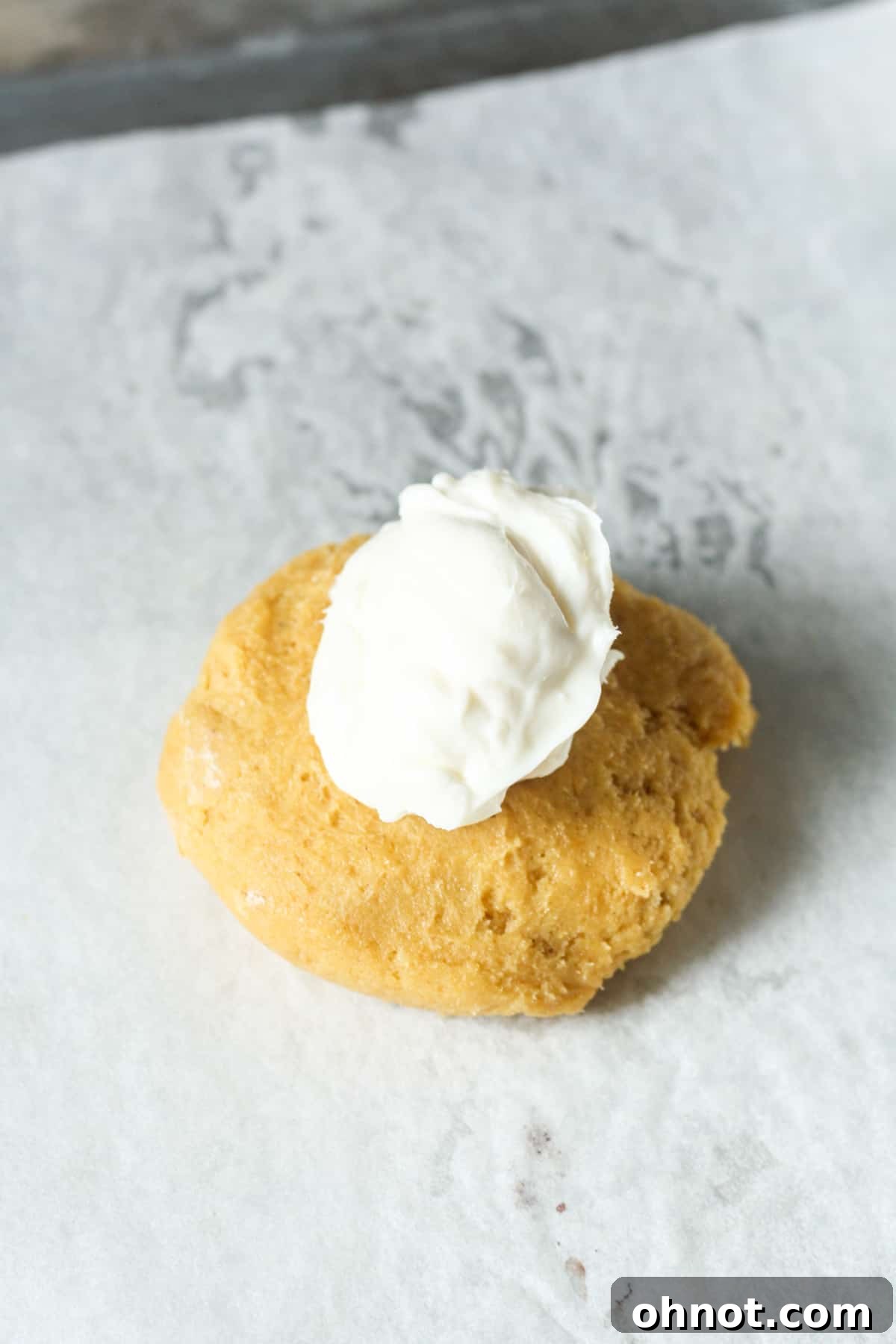 Pumpkin cookie dough with a cream cheese ball placed in the center.