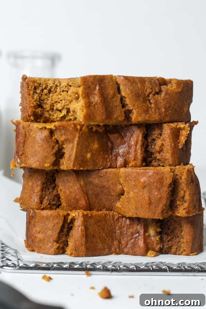 A perfectly baked loaf of moist pumpkin banana bread, showcasing its golden-brown crust and inviting texture, ready to be sliced and enjoyed.