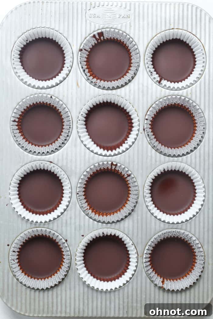 Melted chocolate poured into individual muffin liners.