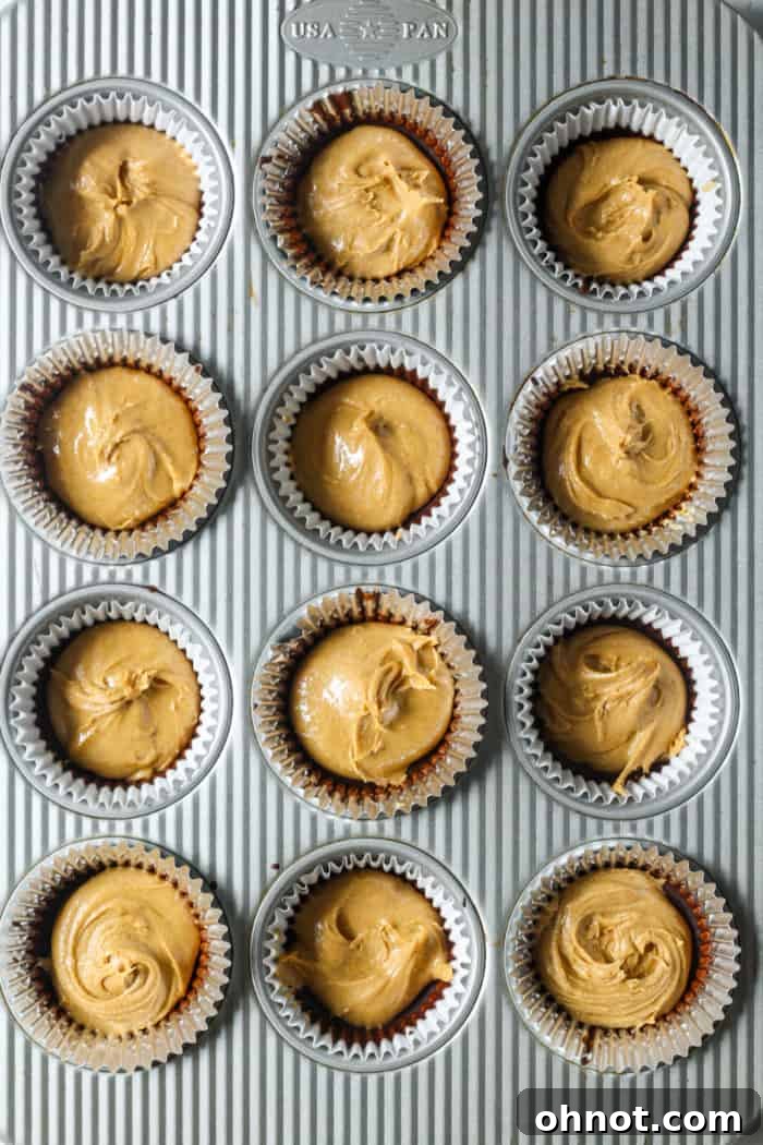 Peanut butter filling added to the chocolate base in muffin liners.
