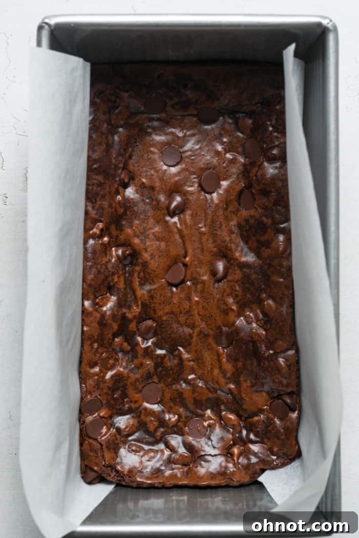 Baked small pan of brownies, golden and crinkly on top.