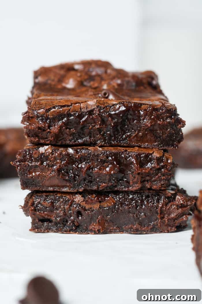 Three gooey brownies, freshly baked and ready to be enjoyed.