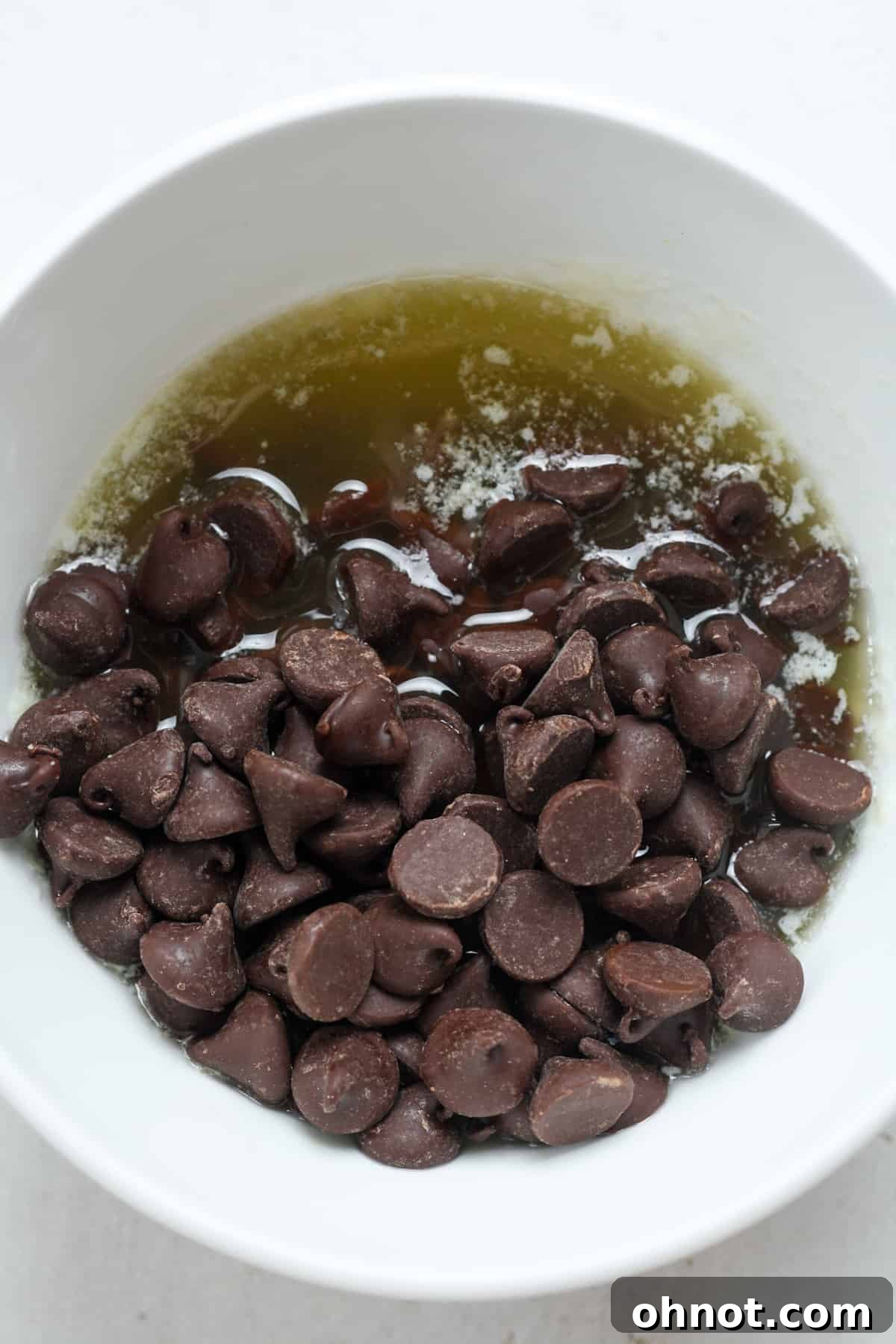 Melted butter and chocolate chips in a bowl.