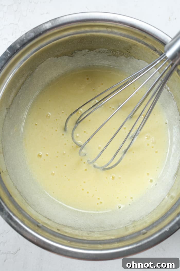 Creamy sugar and egg mixture in a bowl.