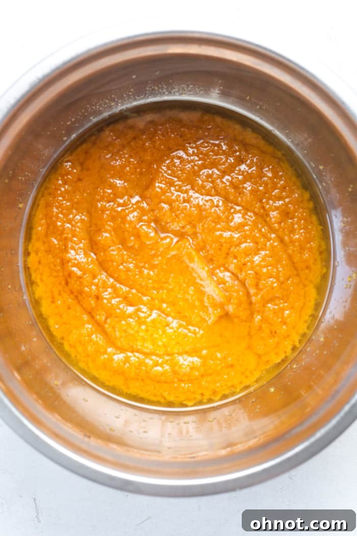 Melted coconut oil mixed with pumpkin purée in a bowl.