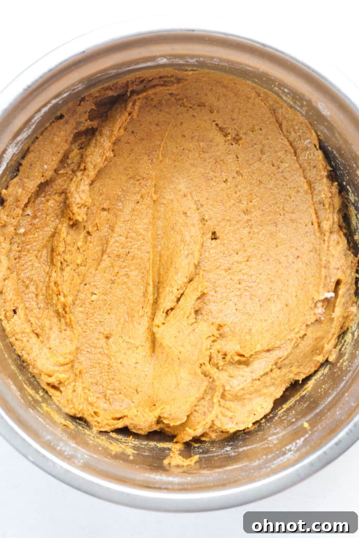 Thick, creamy pumpkin bread batter in a mixing bowl.