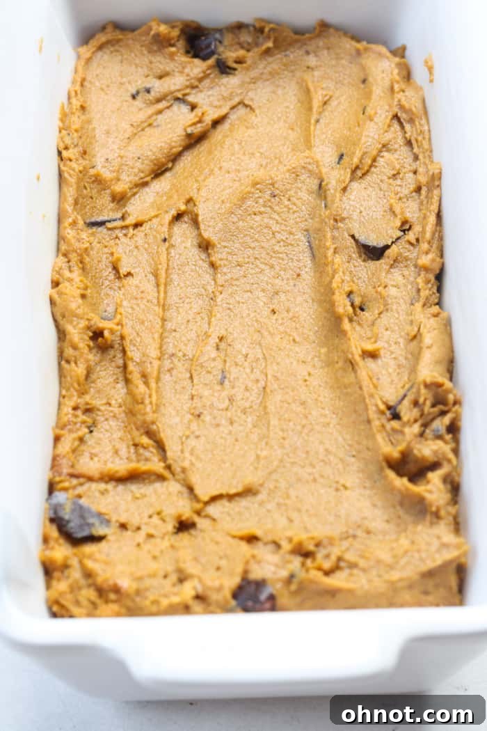 Pumpkin batter placed into a lined bread pan.