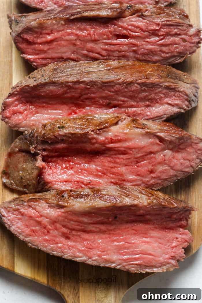 Perfectly medium-rare sous vide tri tip, sliced to show tenderness.