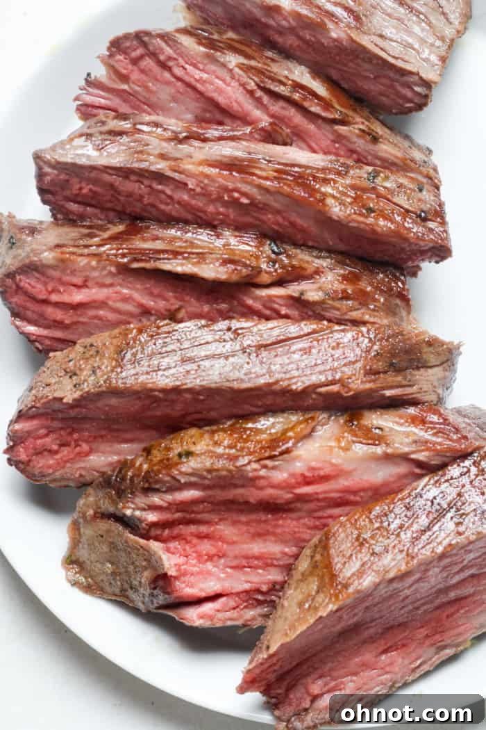 Slices of tender sous vide tri tip steak arranged on a plate.