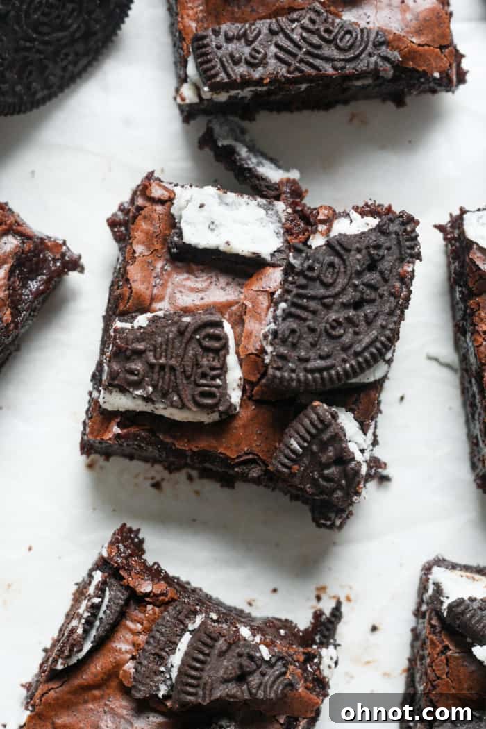 A close-up shot of a perfectly cut Oreo brownie, showcasing its fudgy interior and Oreo layers.