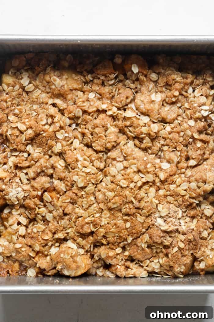Golden brown, bubbly oat topping on a freshly baked gluten-free apple crisp.