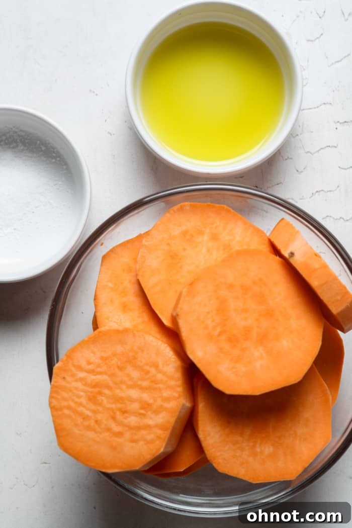 Raw sweet potato rounds neatly sliced for baking.