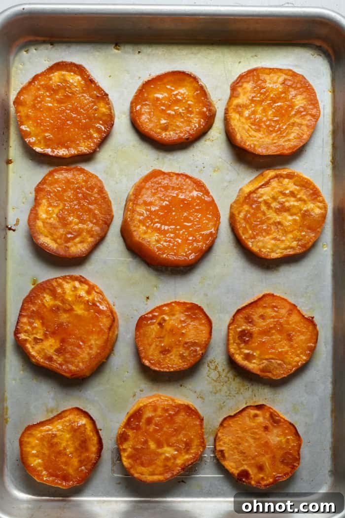 Baked sweet potato slices on the pan, golden brown.