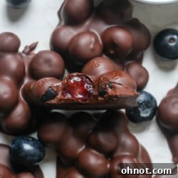 Close-up of a perfectly formed chocolate blueberry cluster, showcasing its crisp coating.