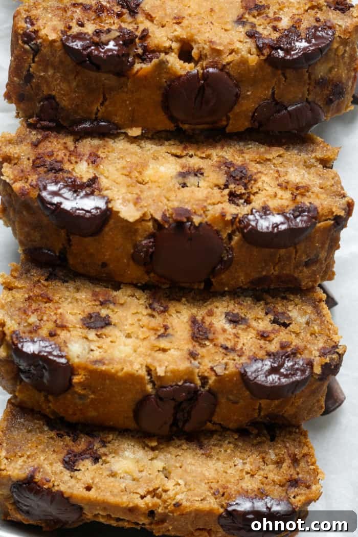 Four perfectly sliced pieces of eggless banana bread, showing its moist and tender crumb.