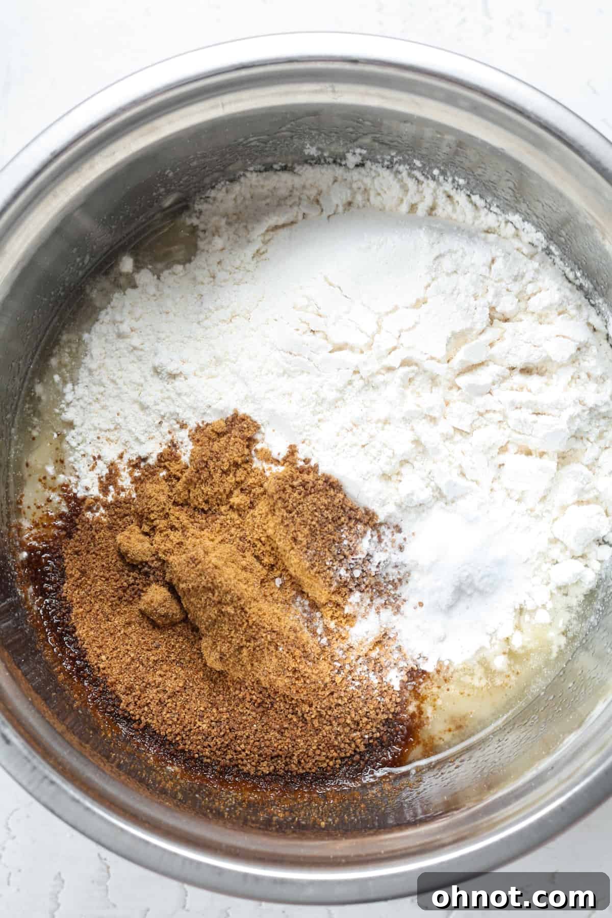 The banana batter in a bowl after dry ingredients have been added, showing a healthy consistency.