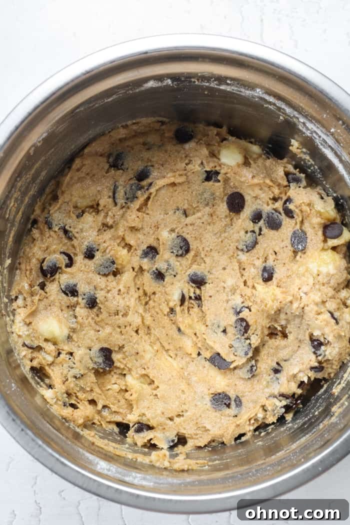 Banana batter with chocolate chips folded in, ready for the pan.