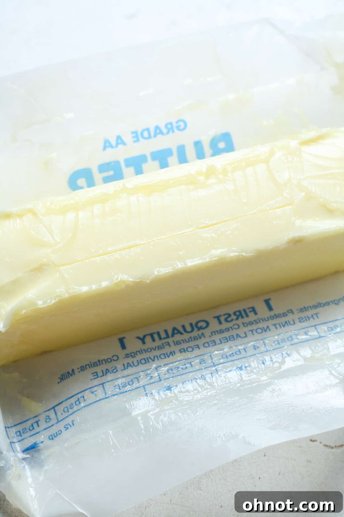A stick of softened butter, ideal for baking.