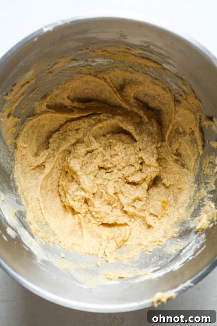Eggs, sugar, and butter mixed together in a bowl, ready for dry ingredients.