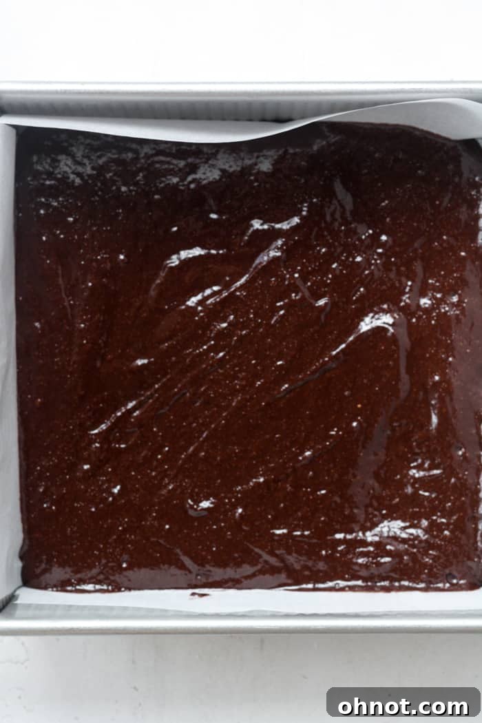 Brownie batter in square pan.